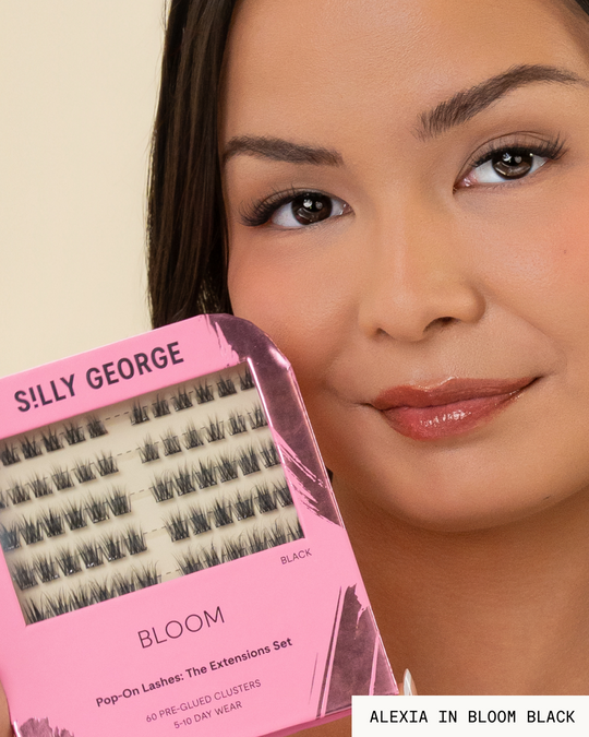 Model Alexia holding a package of black Bloom Pop-On Lashes: The Extensions Set