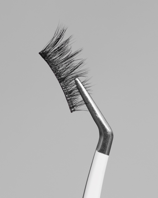 Close up of Dusk Pop-On Lashes: The 75+ Lash held by tweezers