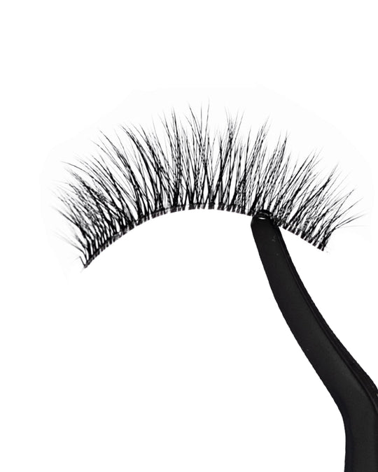 False eyelashes with a black holder on a white background