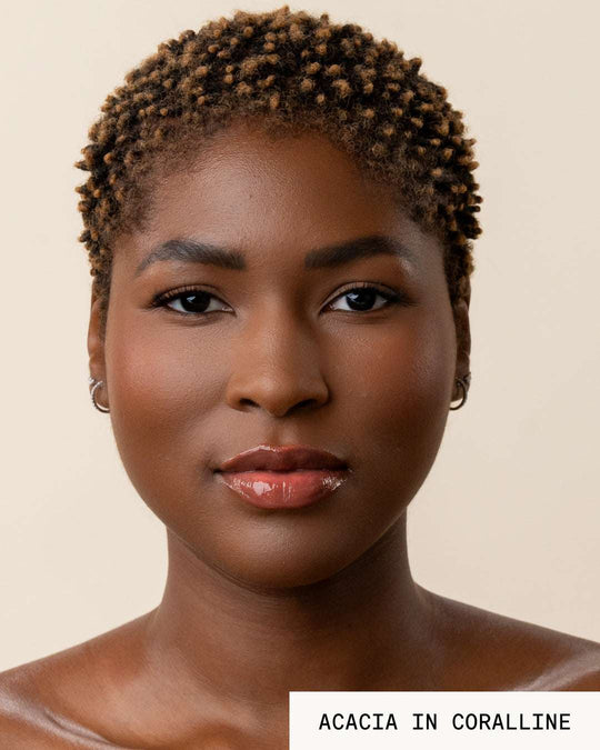 Model Acacia wearing lip gloss revival coralline