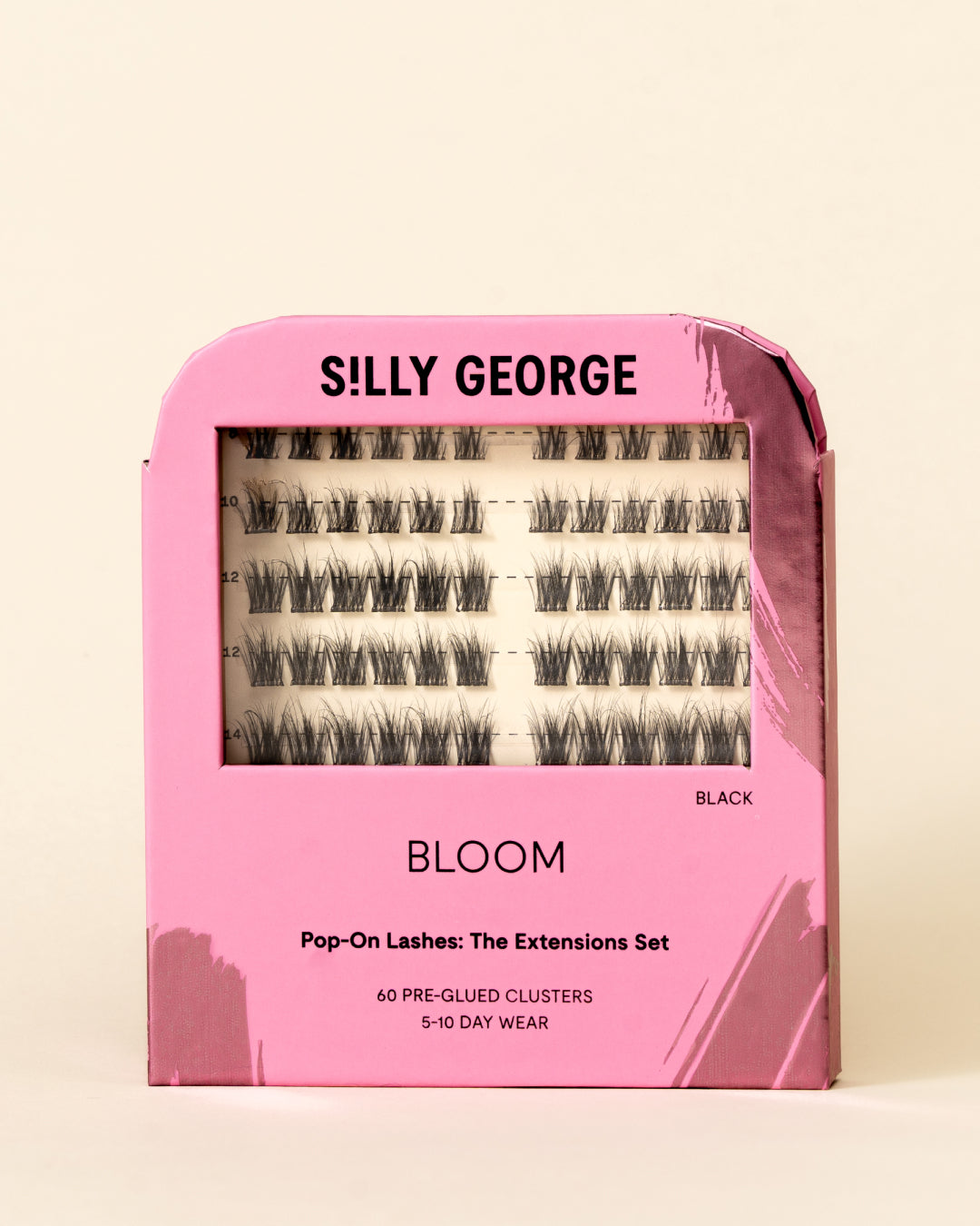 Pink box of false eyelashes with 'SILLY GEORGE' branding on a beige background