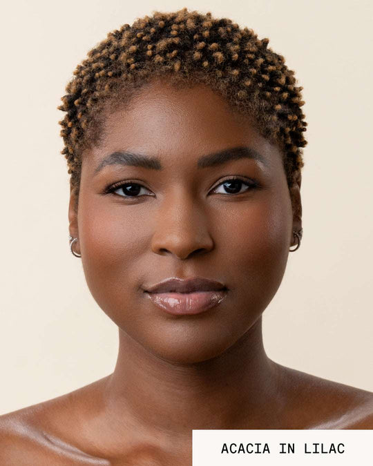 Model Acadia wearing lip gloss revival lilac