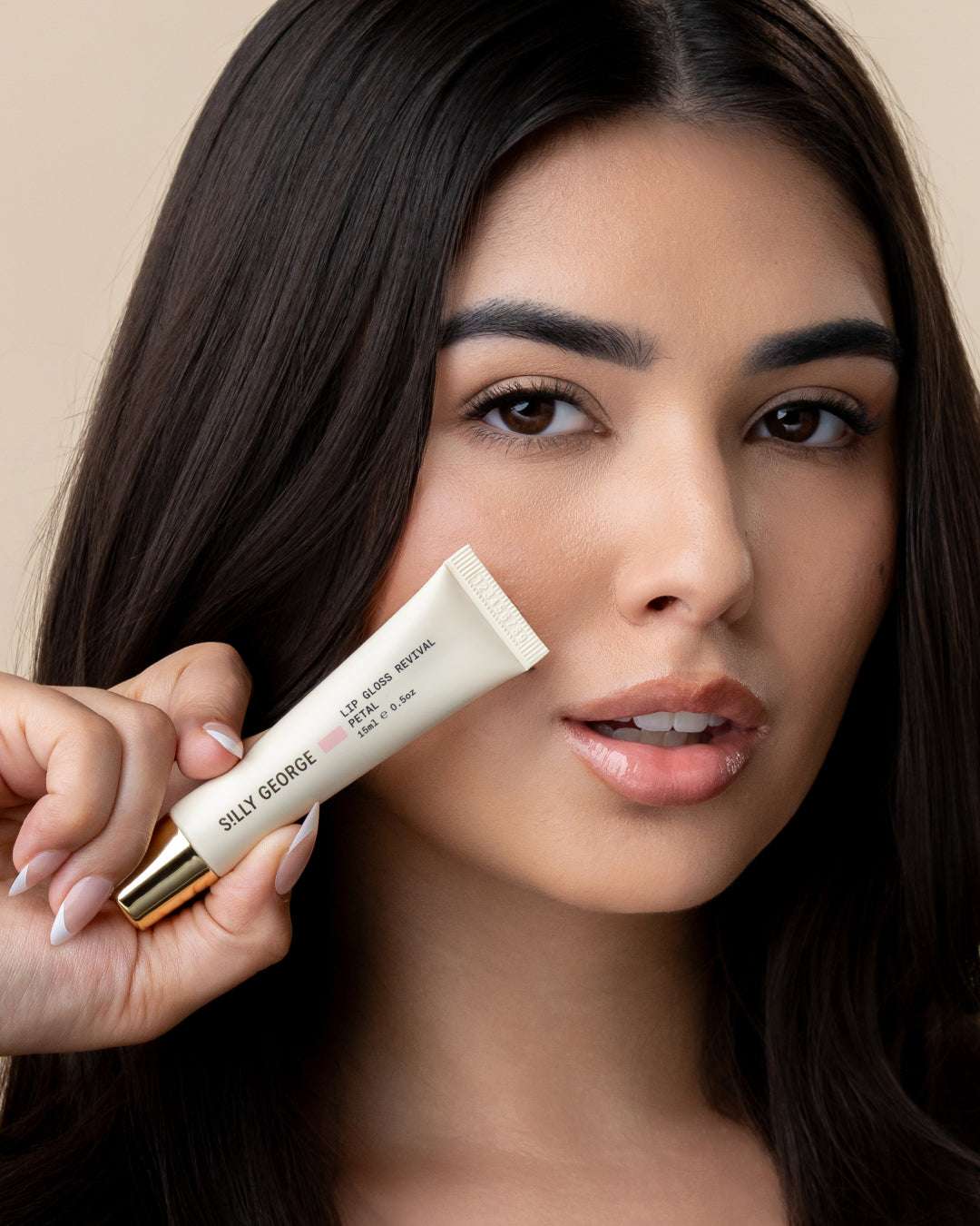 Model holding lip gloss revival petal tube