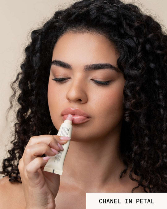 Model Chanel applying lip gloss revival petal